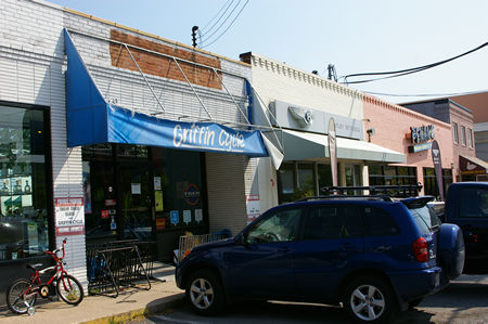 Parking in front of a bicycle repair shop.