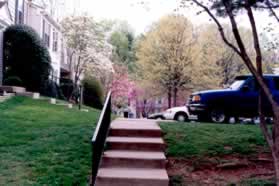 Near the top of the hill turn left onto the steps leading to a sidewalk in front of homes on the left and a street on the right.