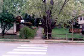 Turn right at the crosswalk and take the trail away from the street on the other side of the street.