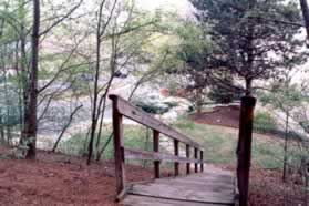 After passing the tennis courts the trail descends a flight of wooden steps.