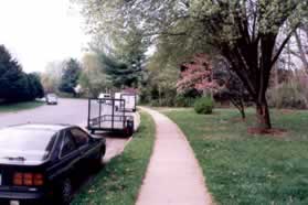 Turn left onto the sidewalk along Wards Grove Cir and follow it a short distance to the asphalt trail on the right.