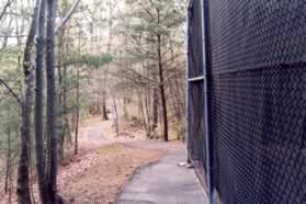 After passing the end of the tennis court go straight to follow the trail down the hill.