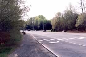 Continue along the gravel shoulder as it approaches the intersection with Roberts Pwy.