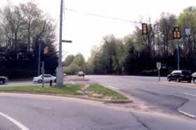 Continue along the side of Burke Centre Pwy until the crossing of Roberts Pwy and cross that road in the crosswalk.