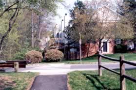 The trail intersects with Green Way. Cross that road and turn right to follow  the sidewalk.