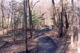 Turn left onto the path just prior to the bridge and street.