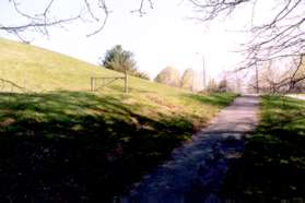 The trail goes up the hill towards the school.
