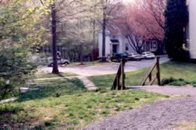 The path turns left to steps leading to a street.