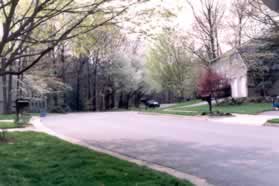 Follow the sidewalk along the right side of New England Woods Ct.