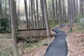 Turn left onto the path that crosses the second bridge on the left.