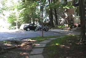 After a short distance turn left and use the flagstone walkway to reach the concrete sidewalk along the right side of Chestnut Wood Ln.