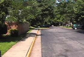 Continue along the sidewalk on the left side of the street until the end of the street.