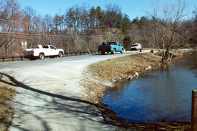 The path joins a road at one end of the lake.