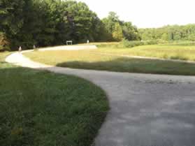 The asphalt trail intersects with the Burke Lake natural surface trail.  Turn left to walk across the dam.