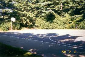 At the top of the hill a basketball court appears on the right.