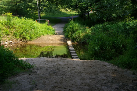 The trail crosses Pohick Creek on columns.