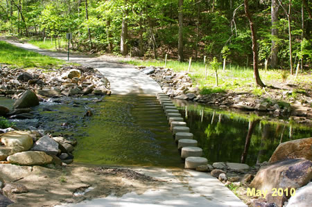 The trail crosses Pohick Creek on columns.