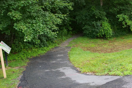 Take the asphalt trail on the east side of Hunter Village Dr. about 130 feet from the intersection with Old Keene Mill Rd. 