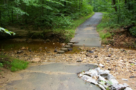 The trail makes a stream crossing on columns.