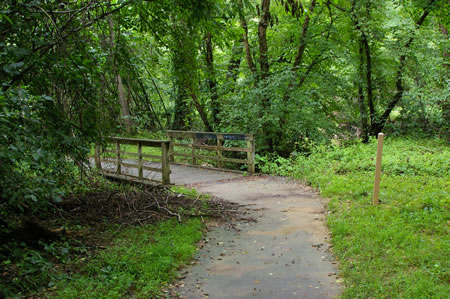 Turn left onto the trail leading to the bridge.