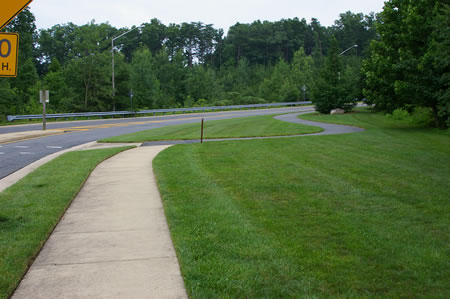 The sidewalk joins an asphalt trail. Turn right to follow that trail along Hunter Village Dr.