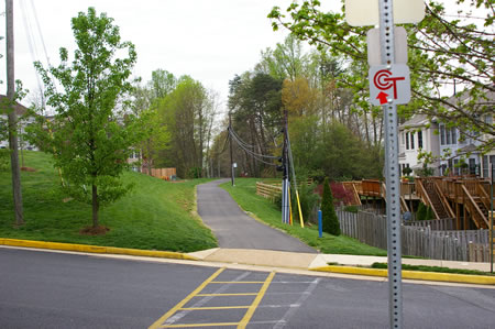 The trail crosses Tanworth Dr. and passes between homes in the next block.