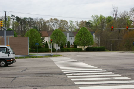 To continue on to the next section of the trail cross the Fairfax County Parkway in the crosswalk. There is a walk light here.