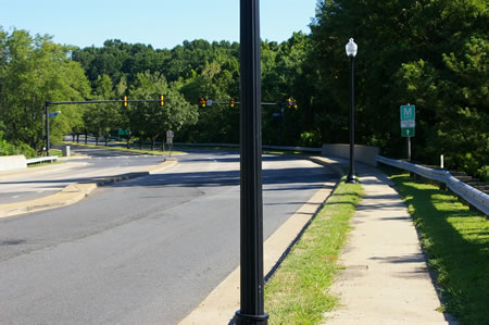 At the street turn right to follow the concrete sidewalk.