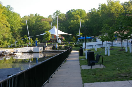 Follow the concrete walkway along the water to the end.