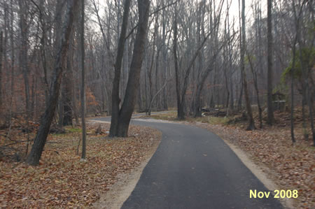 The trail jogs slightly to the left as it crosses a side stream near a side trail to the visitor center.