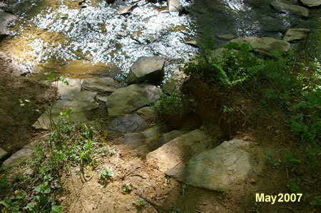 These steps will take you down the bank along the side of the stream.