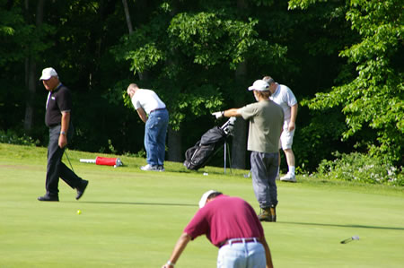 There is lots of activity on the practice green on the left.