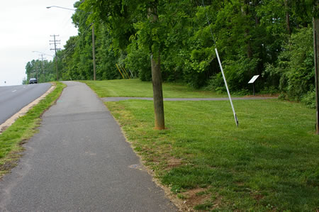 Coming from the prior section of the CCT turn right at the asphalt trail just prior to the Oak Marr Rec Center. Notice the map display case next to the woods.