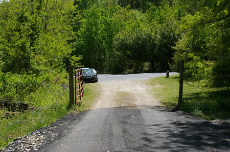 The trail passes through a gate to reach the Occoquan Park access road.