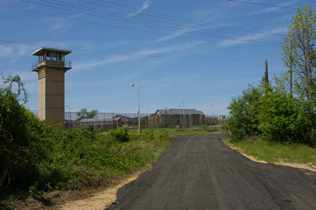 The trail turns right to follow a perimeter road around the former prison.