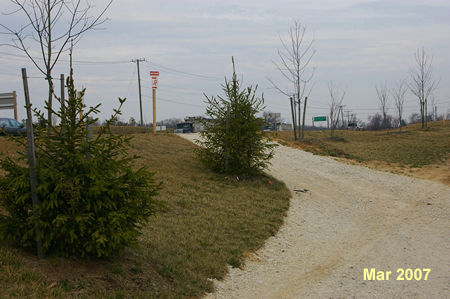 The gravel trail intersects with an asphalt trail along Rt 123. Turn right to follow that trail.