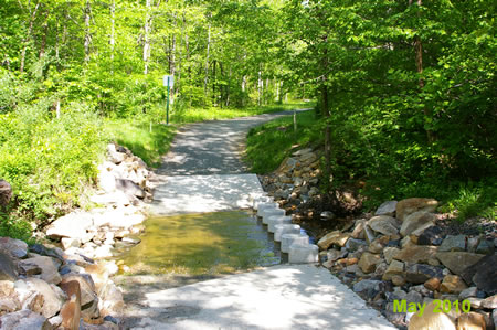 Turn left to cross a side creek. Do not go up the hill by the playground.