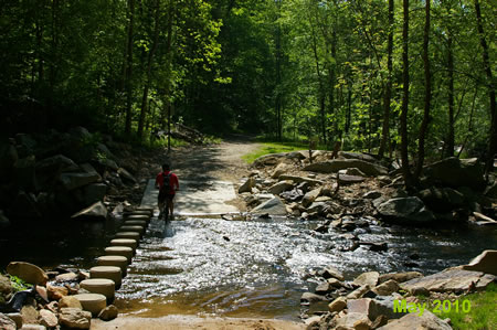 The trail crosses Pohick Creek. Bicycle riding through the creek is dangerous because the surface is slippery.