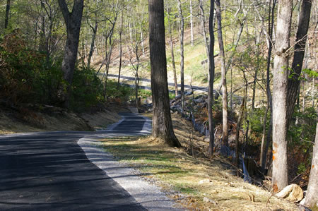 The trail goes down a hill to reach the valley.