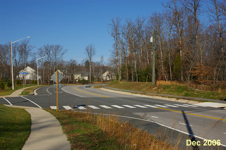 The sidewalk intersects with Pohick Creek View.  Turn right and cross Pohick Road in the crosswalk.