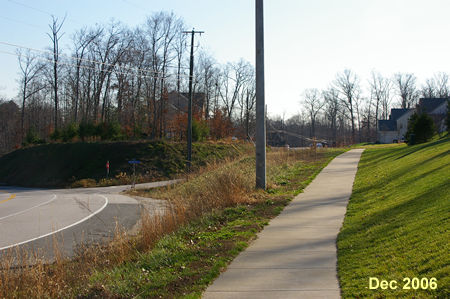 After crossing Pohick Road turn left to follow the sidewalk along that road.
