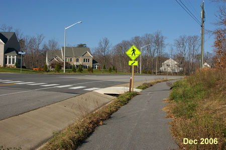 Follow the asphalt trail to the crosswalk leading to Pohick Creek View. Cross Pohick Road using the crosswalk.