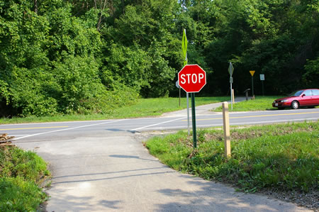 The trail goes through a series of turns and crosses Woodburn Rd.