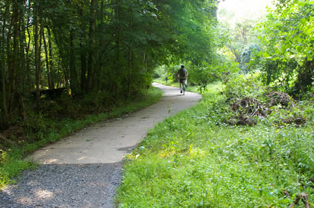 The trail changes from a gravel to a concrete surface here.