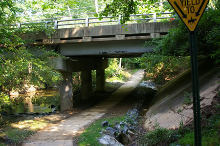 The trail passes under King Arthur Rd. The trail narrows slightly in this section.