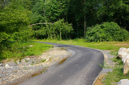 The trail curves to the left as it leaves the parking area. The creek is on the left.