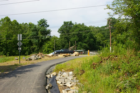 The trail leads to a parking area for a baseball field.