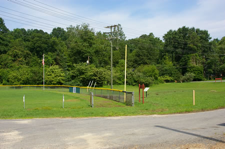 The trail passes through the grass on the outside of the baseball field fence. Use the paved access road if the grassy area is wet.