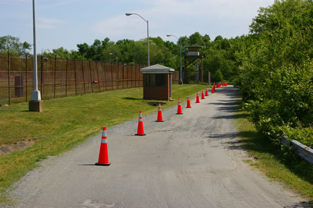 The perimeter road follows a fence along a baseball field.