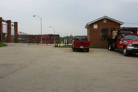 Turn right to follow the perimeter road with the prison fence on the left.